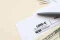 IRS Form 1095-C Employer-Provided Health Insurance Offer and Coverage tax blank lies with pen and many hundred dollar bills on