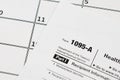 IRS Form 1095-A Health Insurance Marketplace Statement tax blank lies on empty calendar page