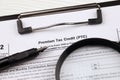 IRS Form 8962 Premium tax cerdit PTC blank on A4 tablet lies on office table with pen and magnifying glass