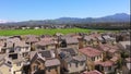 Aerial rising of solar panels in neighborhood of community of houses, Tustin