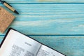 Isaiah open Holy Bible Book on a rustic wooden background with a notebook and pen Royalty Free Stock Photo