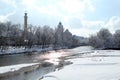 Isar river flows among the cold white landscape of the city of Munich in the snow, a park in winter, the concept of seasonal