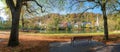 Isar riverside with autumnal trees and bench, spa town Wolfratshausen, upper bavaria