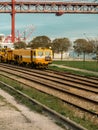 isbon\'s Sunshine Commute - Yellow Train on Rails in Port