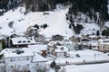 Snow-covered mountain village at the foot of the mountain in winter afternoon, ski resort Ischgl Tyrol Alps