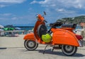 Ischia, Italy - June 20, 2018: Vintage orange Vespa scooter park Royalty Free Stock Photo