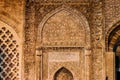 Arabic Quranic calligraphy witten in Thuluth script on the side of a wall, at the Imam Mosque