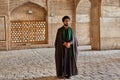 Iranian mullah stands in courtyard of mosque, Isfahan, Iran.