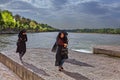 Three Muslim women are walking along the river, Isfahan, Iran.