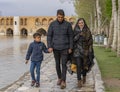 Isfahan, Iran - 2019-04-12 - Family walks beside river in a city park