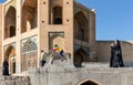 Boy sitting on stone lion at historic Khaju Bridge (Pol-e Khajoo) on Zayanderud River in Isfahan