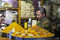 Spice seller in the eastern bazaar. Pile of different colorful spices in the street market