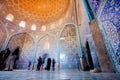 ISFAHAN, IRAN - OCT 14: Tourists inside fantastic designed mosque with tiled dome and walls