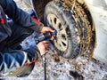 Ishim, Russia - November 27, 2023: A man makes tire of car wheel before cold snow season. Experienced mechanic changes