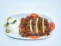 Iskender kebab served with vegetables, yoghurt and french fries