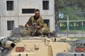 A machine gunner sits on an armored personnel carrier