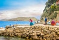 ISLA DEL SOL, BOLIVIA - MAY 12, 2018: Locals build a stone pier in Challa village on Isla del Sol Island of the Sun in Royalty Free Stock Photo