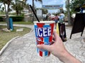 Isla Mujeres, Mexico - April 29 2022: Male hand holding cup with Icee slushed ice. The Icee Company is an American