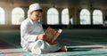 Islam, boy in mosque reading Quran for learning mindfulness and gratitude in faith with kids prayer. Worship, religion Royalty Free Stock Photo