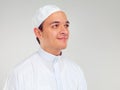 Islam, culture and portrait of muslim man with smile on face in ramadan isolated on grey background. Youth, spiritual Royalty Free Stock Photo