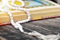 Islam holy book of Muslims, The Quran, is placed on a wooden table, black background,