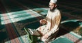 Islam, praying and man in mosque with Quran, mindfulness and gratitude in faith reading. Worship, religion and Muslim Royalty Free Stock Photo