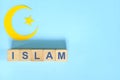 Islam religion concept. Wooden blocks word typography in blue background.