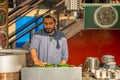 A man making a tea at tea stall in a winter morning