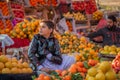 A Young seller is waiting for customers in the Fruit market