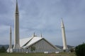 Islamabad, Pakistan - April 15 2018 : Pakistani resting around Faisal Mosque under blue sky in Islamabad