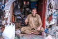 A poor old shoe man cobbler sitting in a street shop of Pakistan