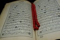 Islamic Book Koran with rosary on background