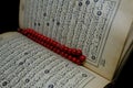 Islamic Book Koran with rosary on background