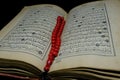 Islamic Book Koran with rosary on background