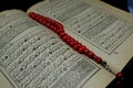 Islamic Book Koran with rosary on background