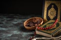 The holy Quran and Tasbih rosary beads on dark background