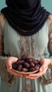 Islamic cuisine Woman holds plate of sweet dates for iftar