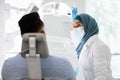 Islamic Dentist Doctor Lady Having Check Up With Male Patient In Clinic