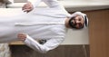 Islamic entrepreneur in white kandura and headwear posing in office