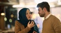 Islamic European couple shares laughter and enjoyment while savoring delicious pastries during iftar in the holy month Royalty Free Stock Photo