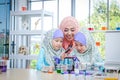 Islamic female teacher teaches science to girls in the classroom