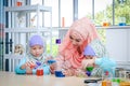 Islamic female teacher teaches science to girls in the classroom