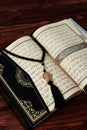 Islamic Holy Book Quran with rosary beads on wooden table background. Kuran the holy book os Muslims. Ramadan concept.