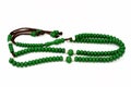 Islamic rosary in green color with 99 rosary beads that Muslims use it to give praise to Allah using sentences to mention God like