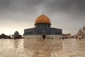 Islamic shrine Dome of the Rock with gold leaf and dark clouds on Temple Mount in Jerusalem Old City, Israel