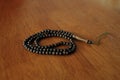 Islamic tasbih bead on wooden table background