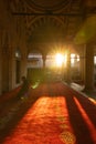 Islamic vertical photo. Muslim man praying in the courtyard of a mosque.