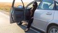 Islamic woman sitting the car with the front door wide open