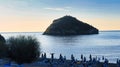 The island of bergeggi immersed in the brilliant colors of dawn