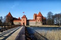 Island castle in Trakai and tourist near it. One of the most popular touristic destinations in Lithuania in early spring Royalty Free Stock Photo